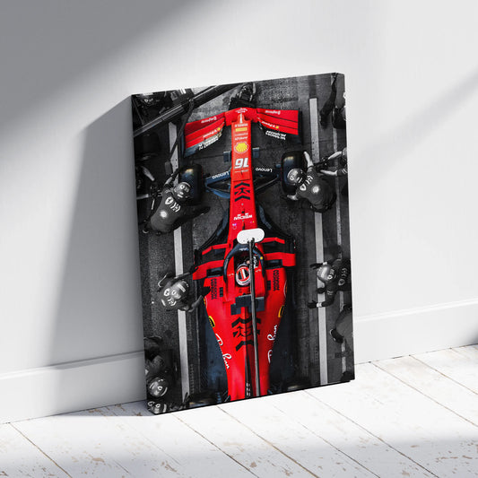 Top-view selective-red photograph of Ferrari #16 (Charles Leclerc) in a pit stop, printed on Aniatic fade-proof PolyCanvas for motorsport wall art.